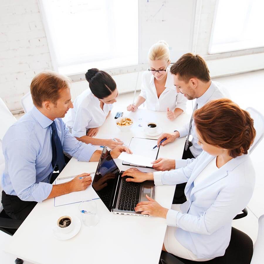 EHR optimization assessment meeting, consultants and hospital staff meet at conference table with computer