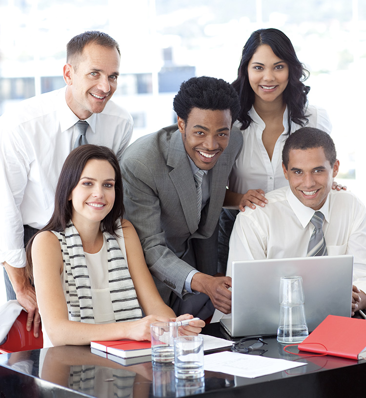 Happy core software testing team around computer screen